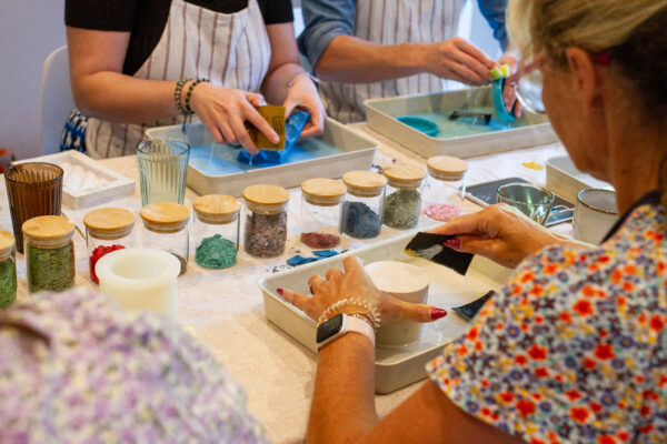 Jesmonite Craft Workshop with terrazzo in jars and participants sanding.